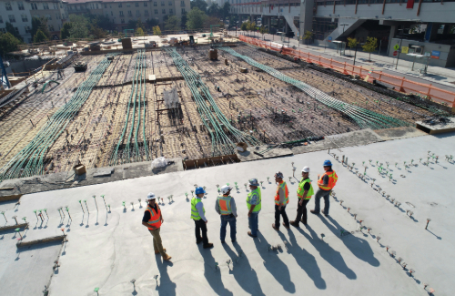 seven construction workers standing in a line on a construction site