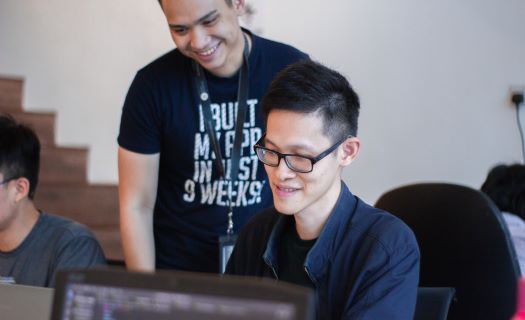 A mentor guiding a coding student