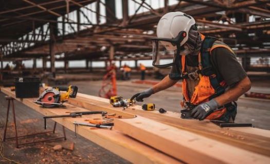A woodworker assesses which tools he needs to use next. 