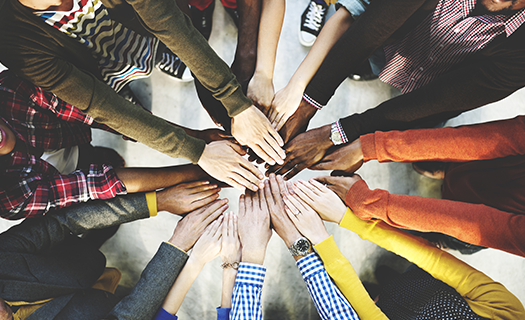 diverse group hands together