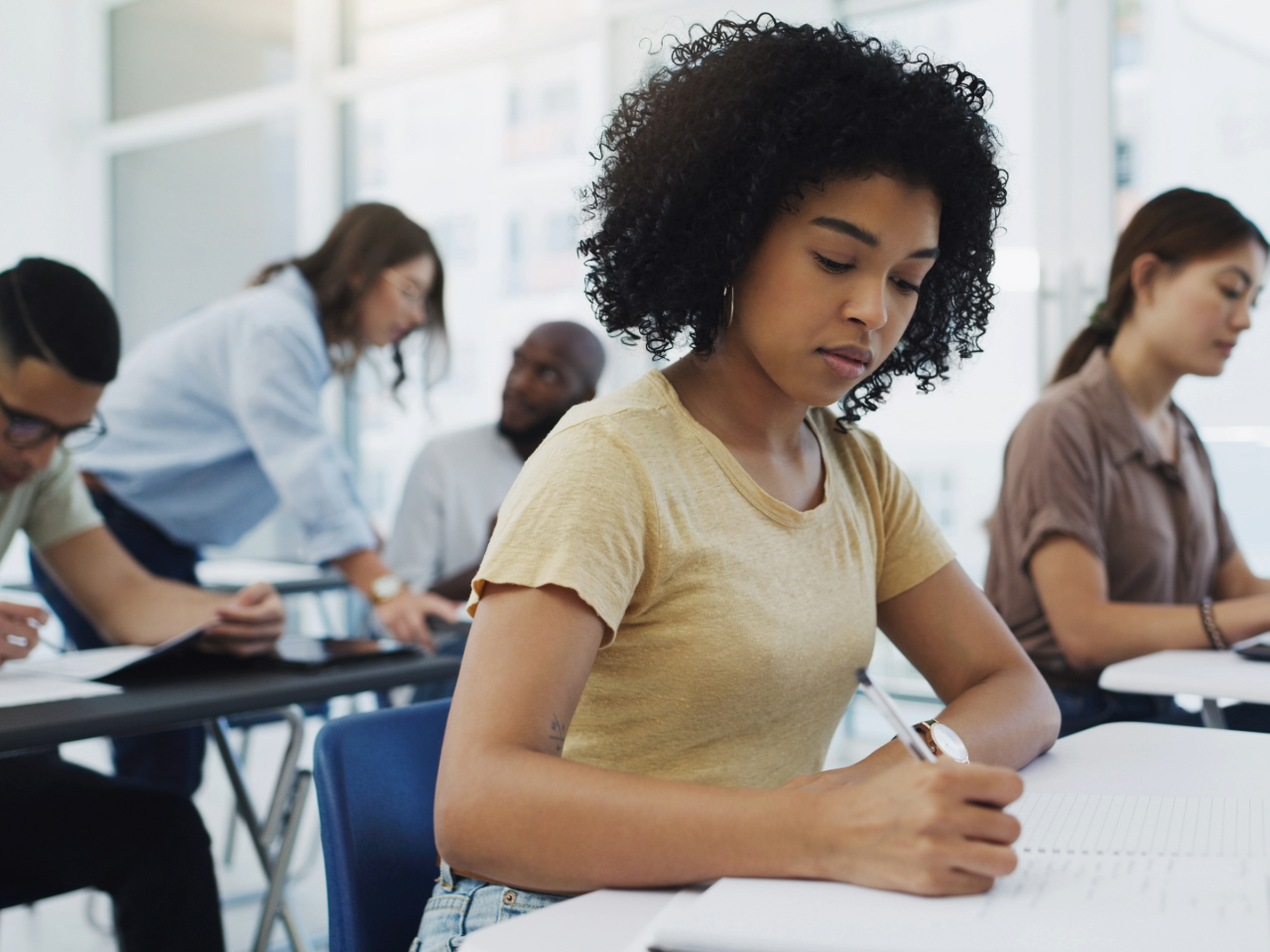 Adult learners in well-lit classroom