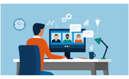 Person sitting a desk looking at computer for virtual meeting