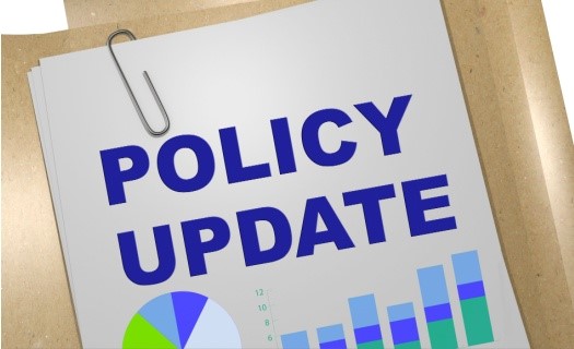 Paper with the text "Policy Update" in bold blue letters