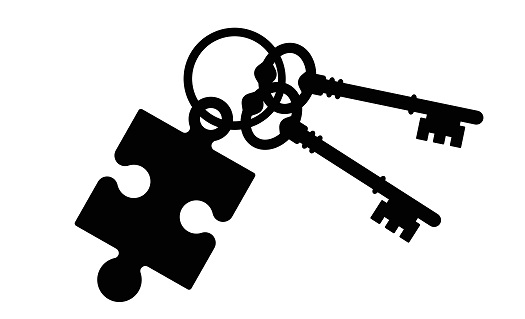 Two keys connected to a puzzle piece keychain