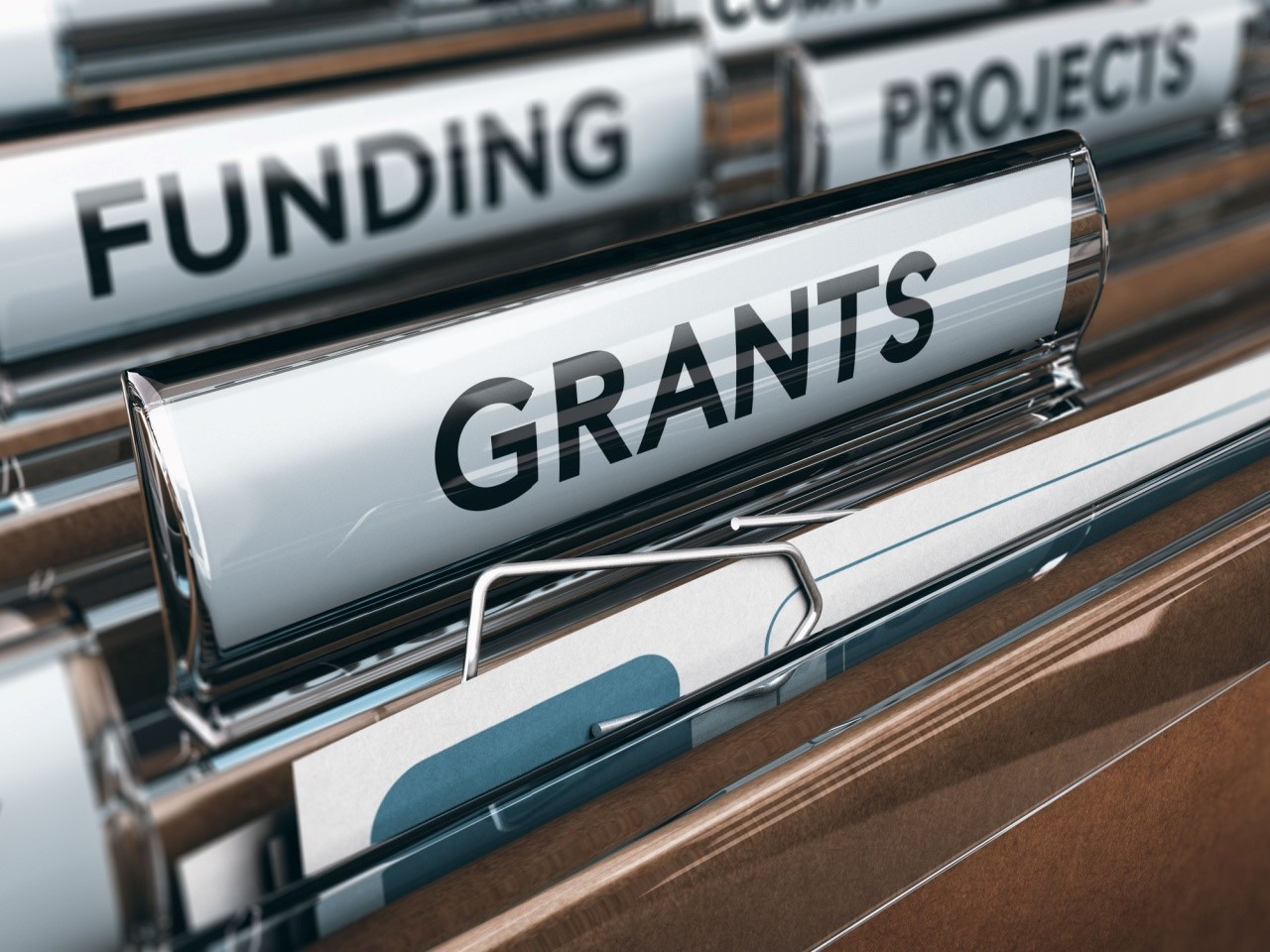 File folders with the words funding, projects, and grants written on them.