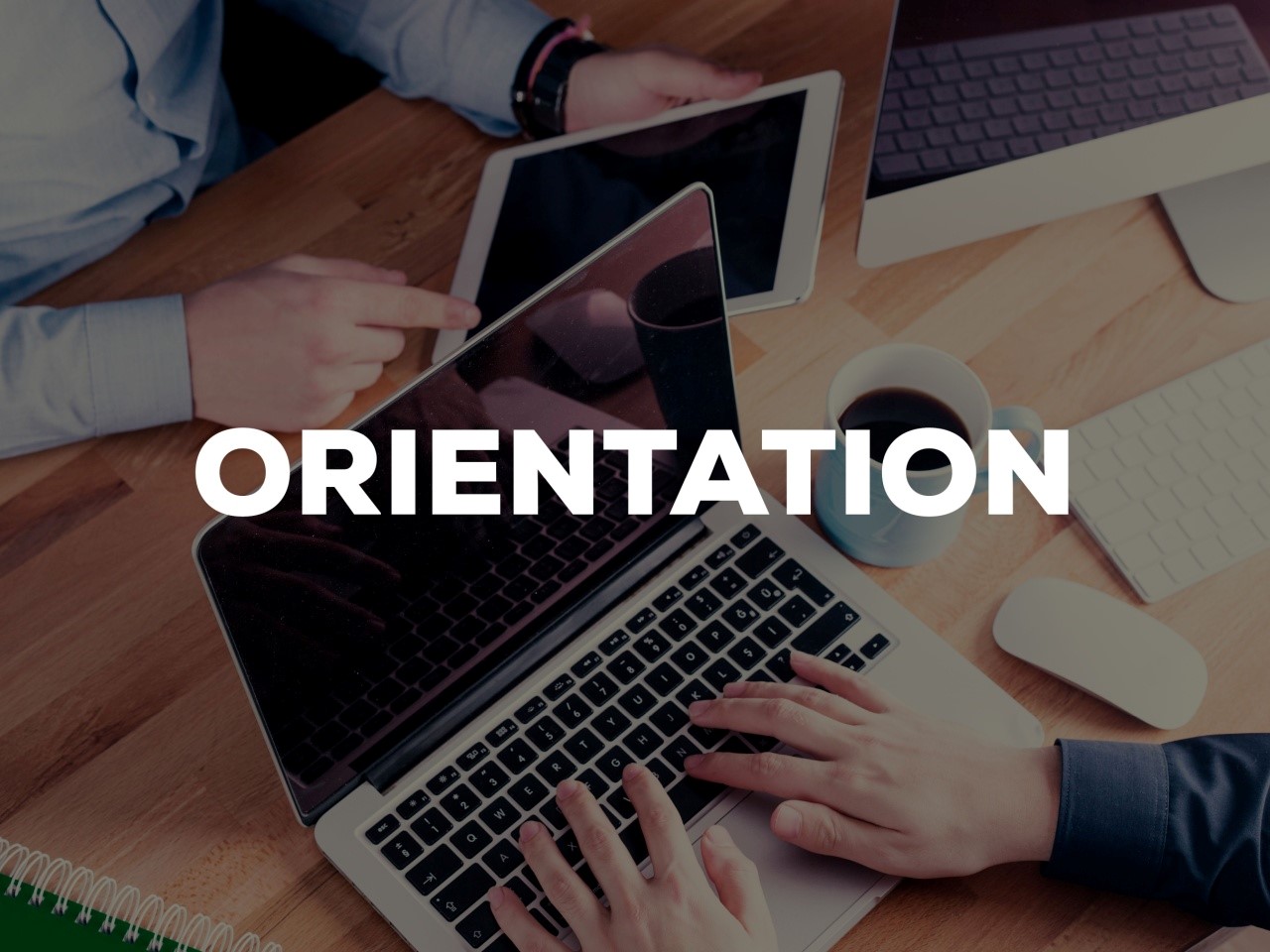 The word orientation is shown over two people working on laptops
