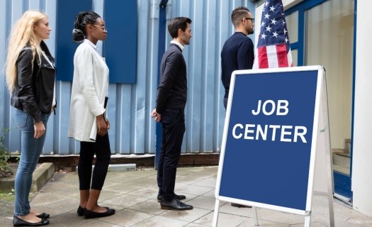 American Job Center sign with people standing in line