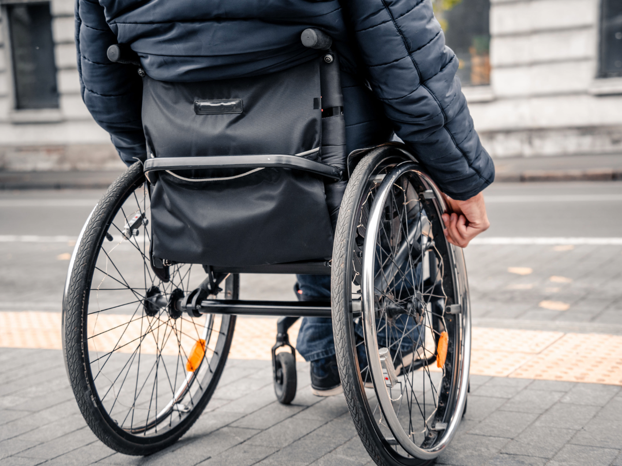 Close up of individual using a wheelchair
