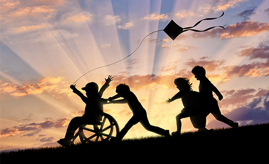 Children flying a kite on a hill