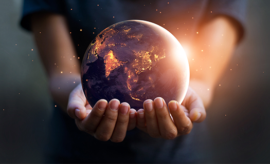 Earth being held by two small hands