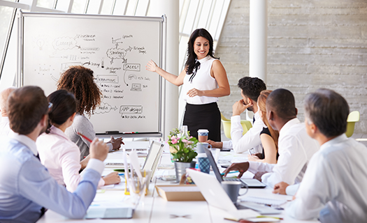 hispanic-businesswoman-leading-meeting-boardroom-table