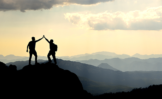 two silhouettes on mountain high five