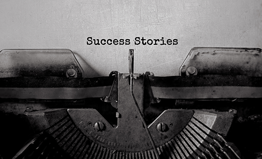 typewriter with the words "success stories" typed on a page