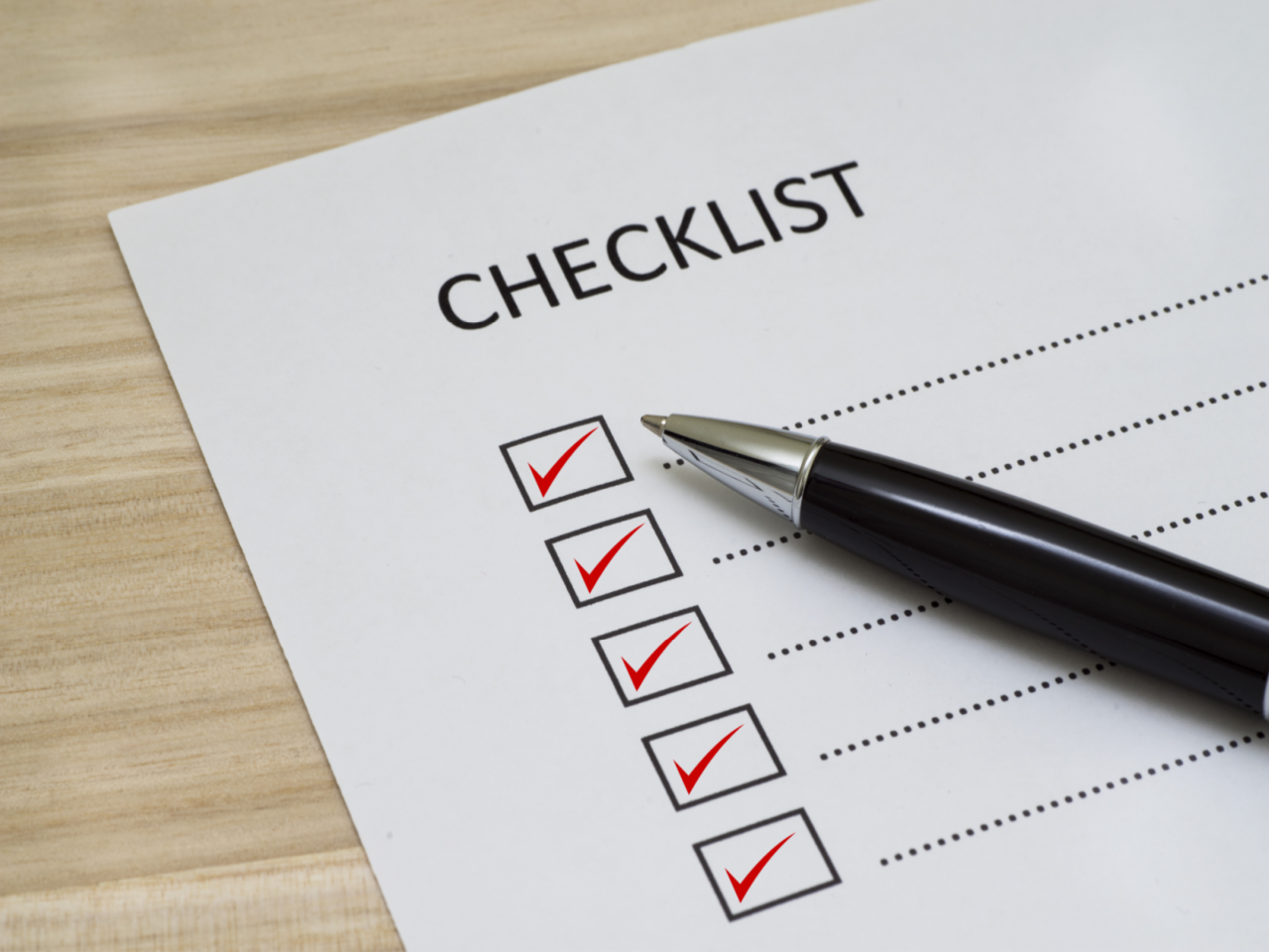 Red checks in checklist boxes with pen
