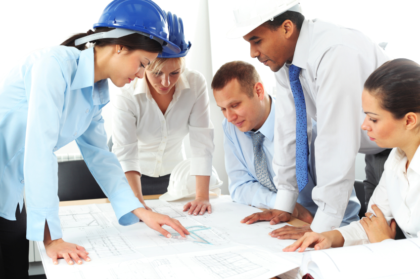 Construction workers and architects collaborating on a project