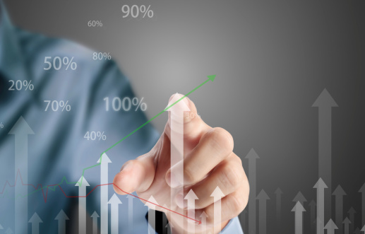 Man pointing to a bar chart on a screen