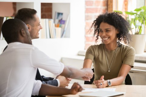 A newly hired applicant shakes hands with HR recruiting manager