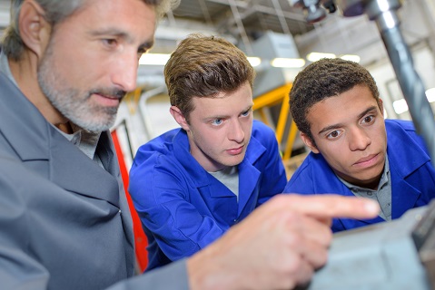 Teacher and two students solve a problem hands-on