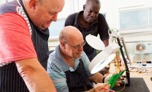 Diverse group of three older men inspecting a circuit