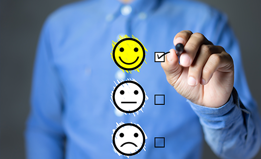 Picture of man checking off a happy face survey