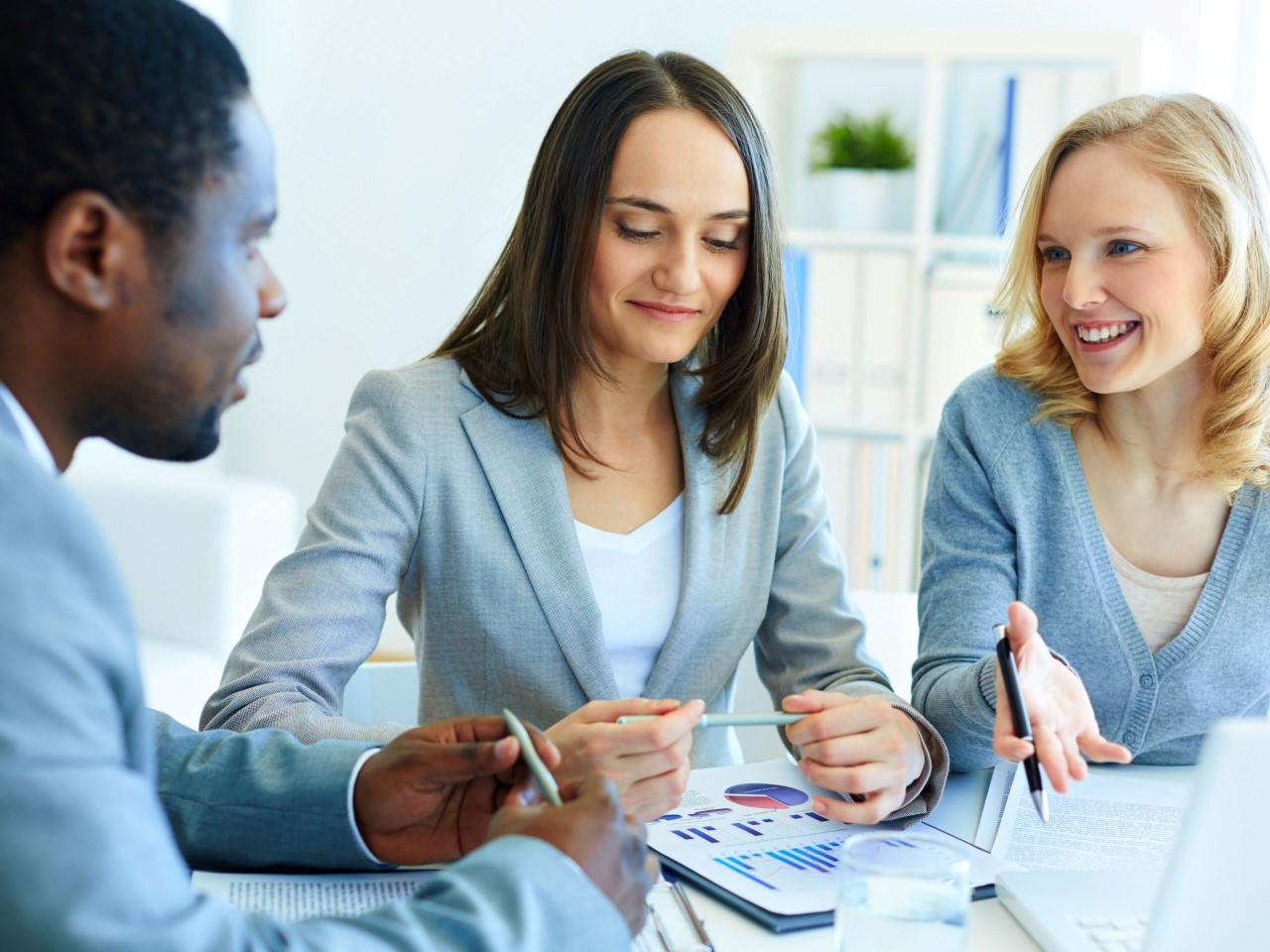Three office workers making data driven decisions