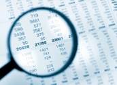 Imge of a magnifying glass over financial report