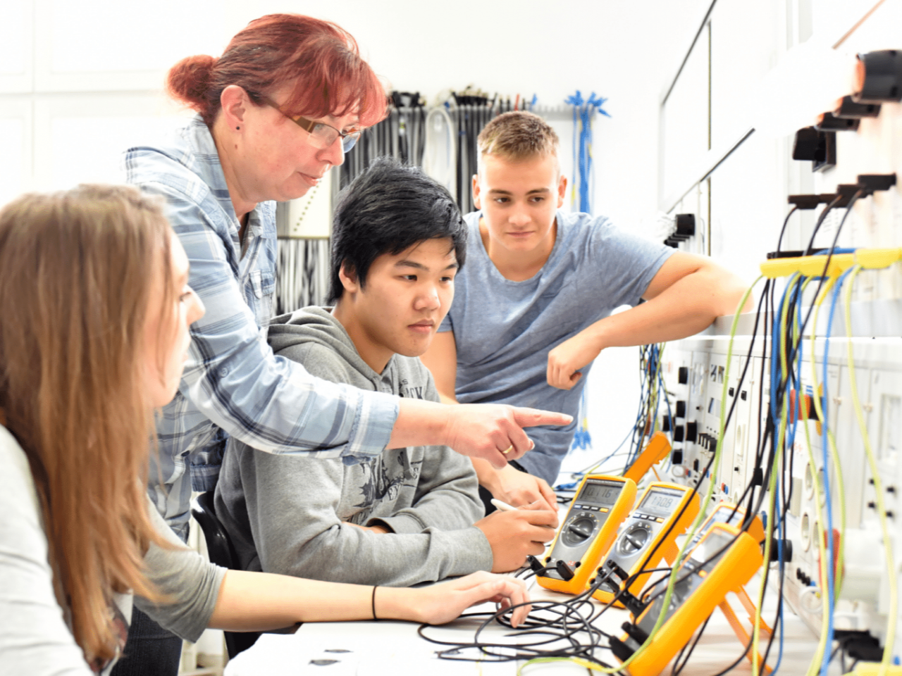 Teacher and three students in a CTE classroom