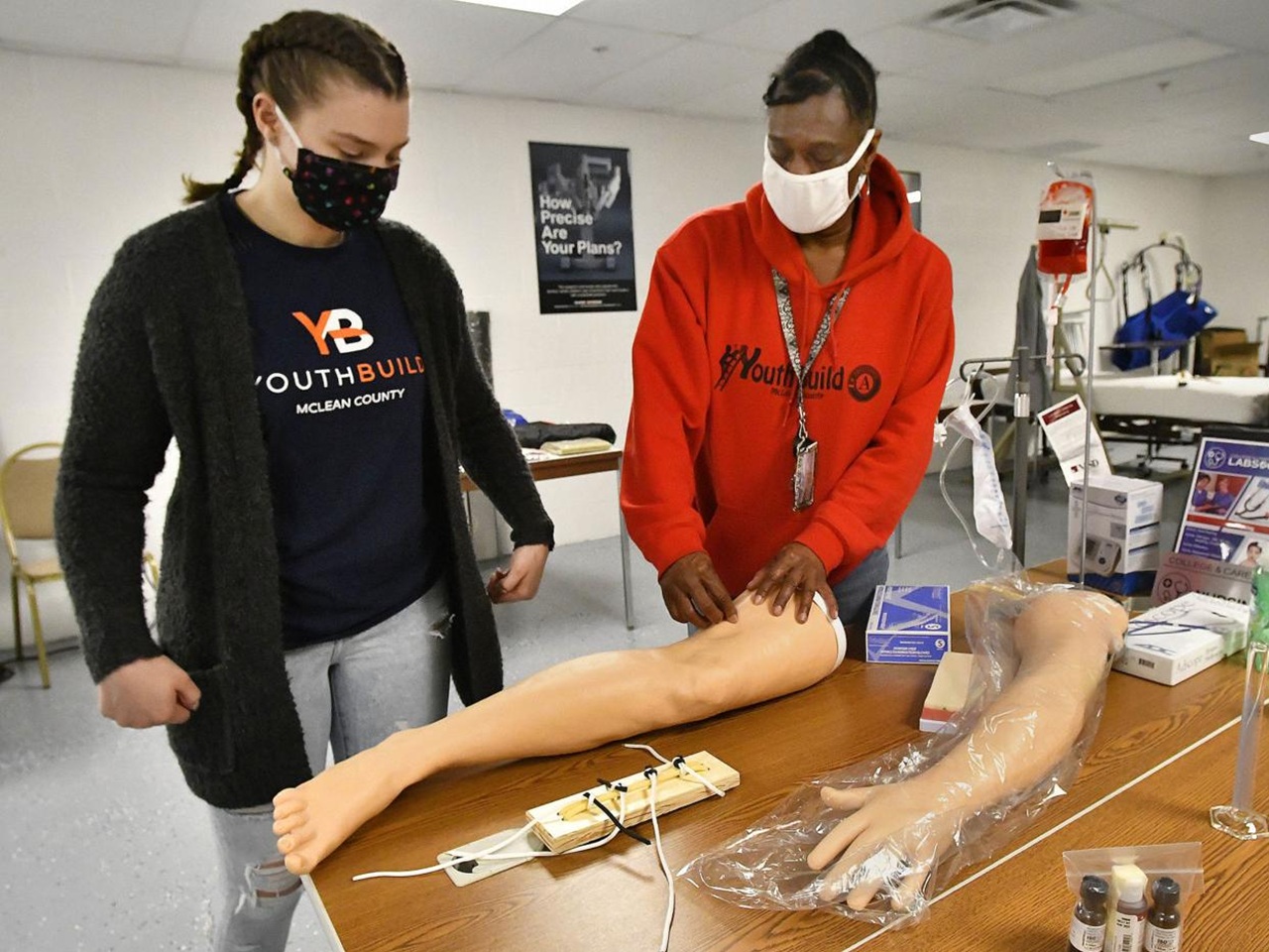 Students practice healthcare skills on dummies