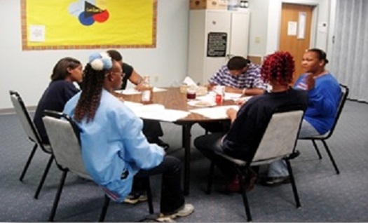 Group of young people meeting around a table