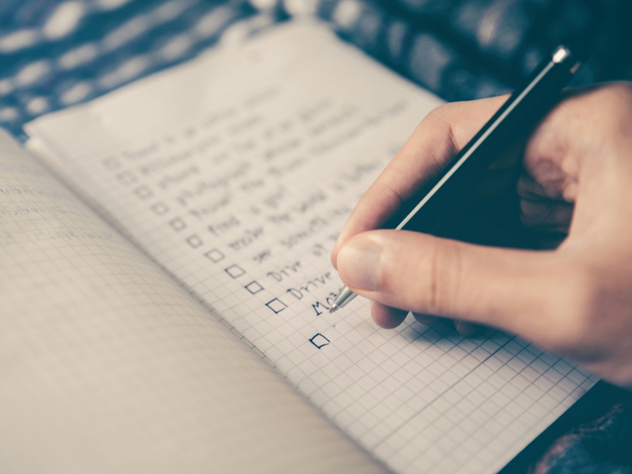 hand writing goals in a notebook