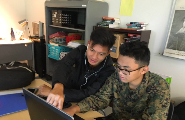 A senior student working on resume writing with one of the freshman students