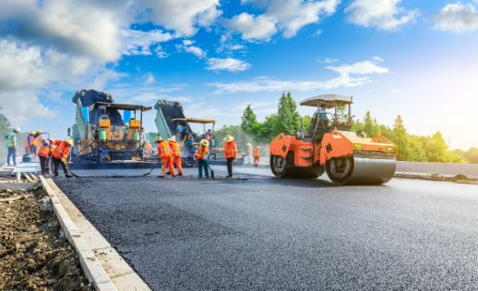 Distance photo of a large road construction project under blue skies.