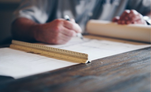 Man at drafting table with blueprints