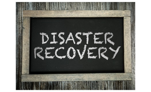A chalkboard with the words DISASTER RECOVERY printed in all caps