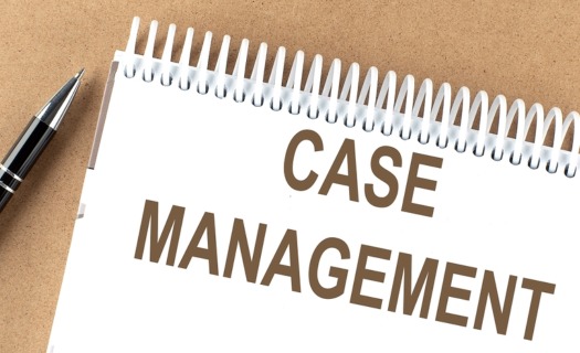 A spiral pad with CASE MANAGEMENT written on it and a pen beside.