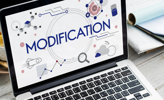 Laptop with the word modification on the screen. 