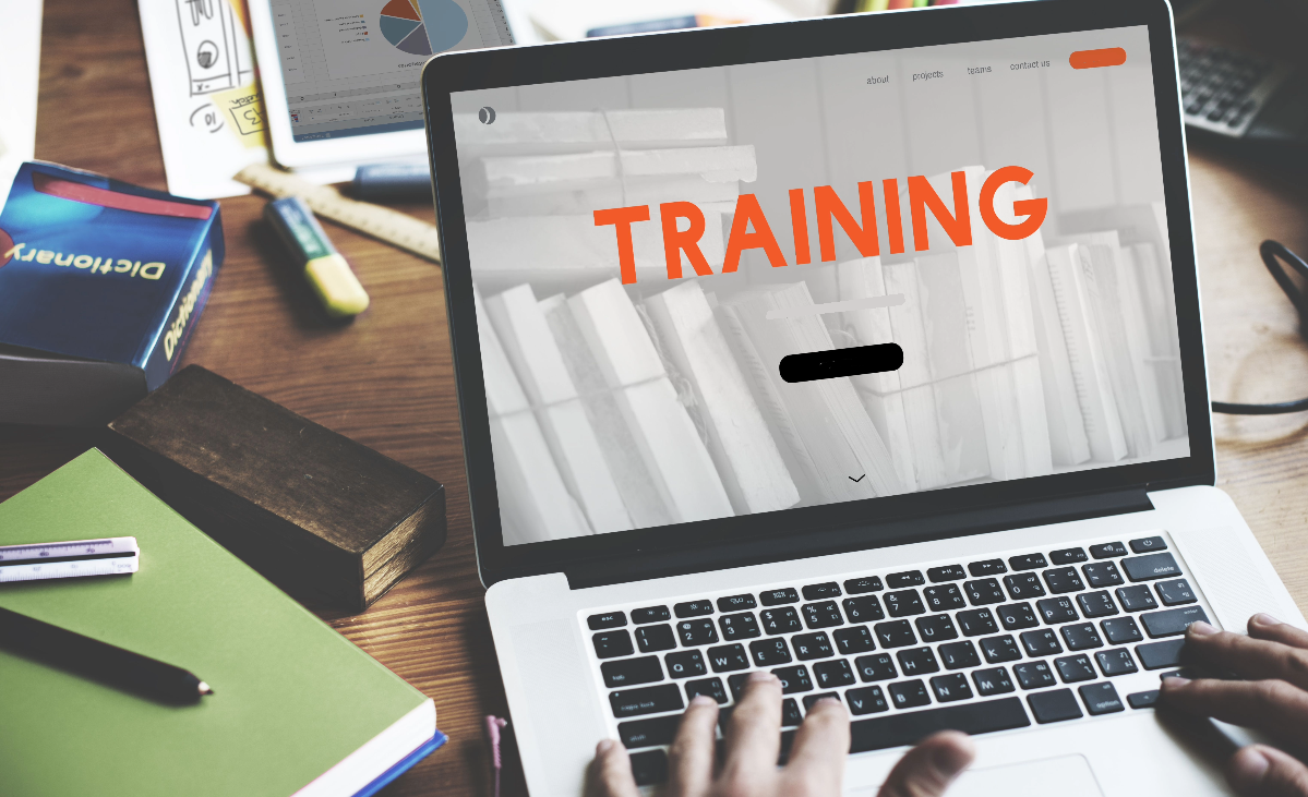 A person using a laptop to update online training.