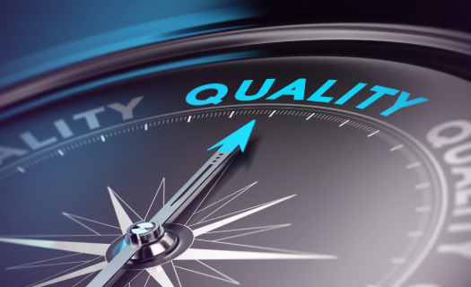 A modern compass with the needle pointed toward the word QUALITY.