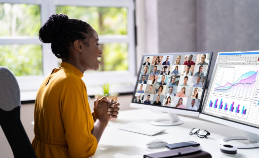 Woman attending an online meeting in brightly lit, modern office