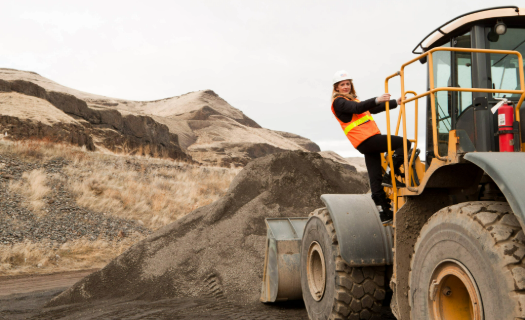 Construction worker on large equipment on a construction site