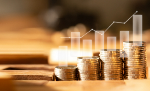 Stacks of coins with an image of bar graphs overlayed