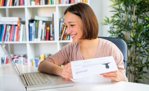 Person holding a resume and smiling in on online job interview.