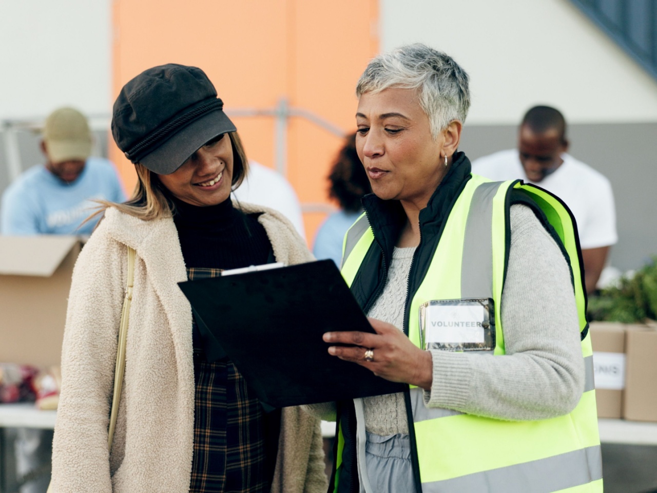 Woman volunteering showing manager a checklist