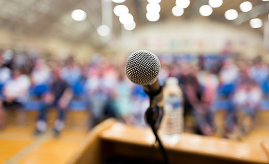 close-microphone-on-podium-auditorium.png