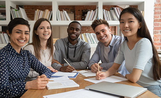 happy-mixed-race-students-gathered-classroom.png