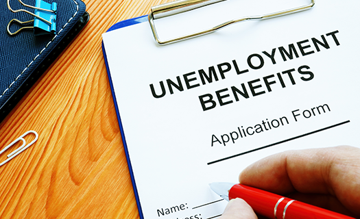 man-fills-unemployment-benefits-application-form.png