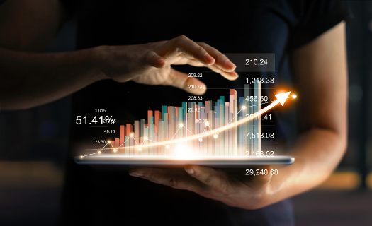 Businessman holding tablet and showing a growing virtual hologram of statistics, graph and chart with arrow up on dark background. 