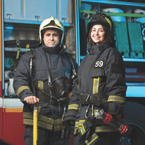Image of happy fireman and woman near fire truck at station